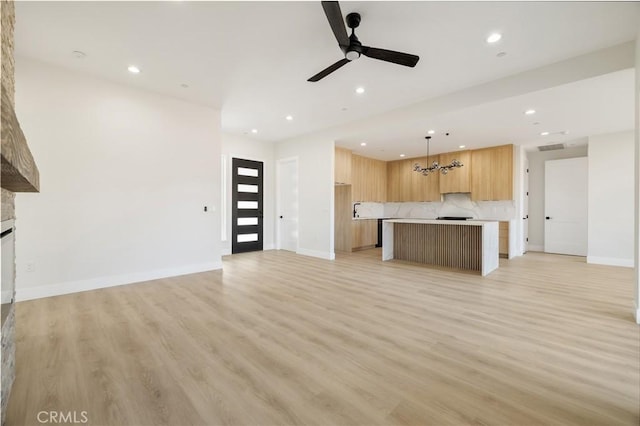 6638 Dolores Dr, Paradise, CA 95969 - unfurnished living room featuring recessed lighting, a ceiling fan, light wood-type flooring, a chandelier, and a fireplace