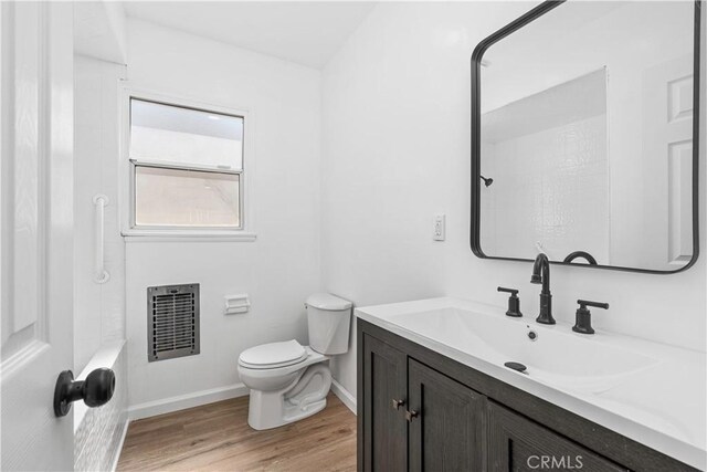 1920 Doolittle Ave, Bakersfield, CA 93304 - bathroom featuring vanity, wood finished floors, heating unit, and a shower