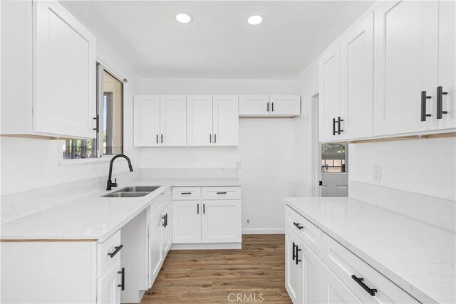 1920 Doolittle Ave, Bakersfield, CA 93304 - kitchen featuring wood finished floors, white cabinets, and recessed lighting