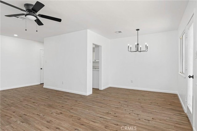 1920 Doolittle Ave, Bakersfield, CA 93304 - empty room featuring a chandelier, wood finished floors, ceiling fan, and recessed lighting