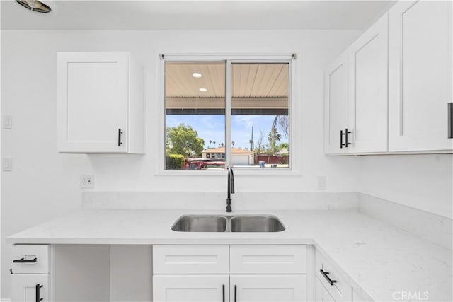 1920 Doolittle Ave, Bakersfield, CA 93304 - kitchen with white cabinets, recessed lighting, and light stone counters