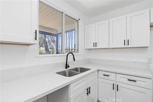 1920 Doolittle Ave, Bakersfield, CA 93304 - kitchen featuring white cabinetry and light stone countertops