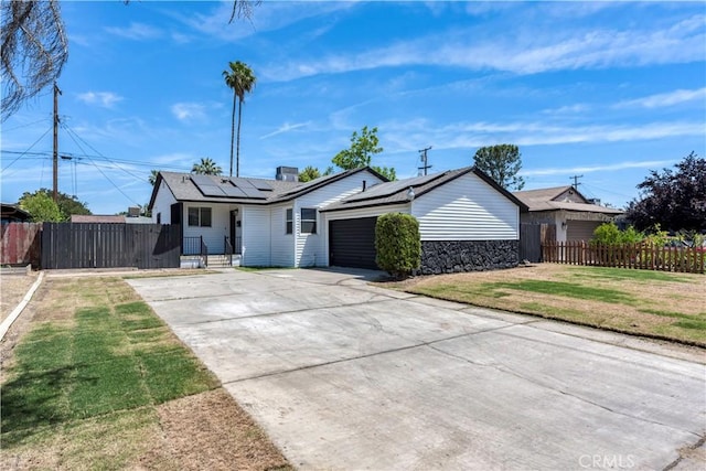 1920 Doolittle Ave, Bakersfield, CA 93304 - single story home featuring solar panels, driveway, and a garage