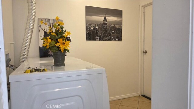 856 N Van Ness Ave Unit 3, Los Angeles, CA 90038 - washroom with washer and dryer and light tile patterned floors