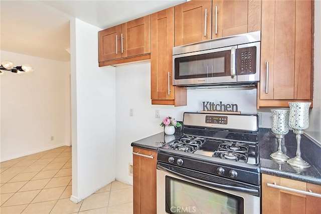 856 N Van Ness Ave Unit 3, Los Angeles, CA 90038 - kitchen featuring stainless steel appliances, brown cabinets, and light tile patterned flooring