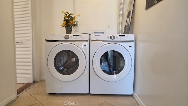 856 N Van Ness Ave Unit 3, Los Angeles, CA 90038 - washroom featuring washing machine and clothes dryer and light tile patterned floors