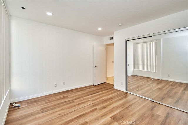 856 N Van Ness Ave Unit 3, Los Angeles, CA 90038 - unfurnished bedroom featuring wood finished floors, a closet, and recessed lighting