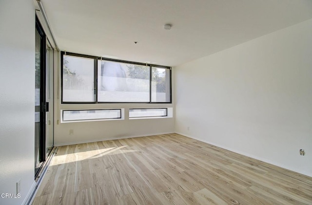 121 S Hope St Unit 321, Los Angeles, CA 90012 - empty room with wood finished floors and a smoke detector