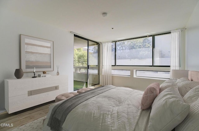 121 S Hope St Unit 321, Los Angeles, CA 90012 - bedroom featuring wood finished floors and access to outside