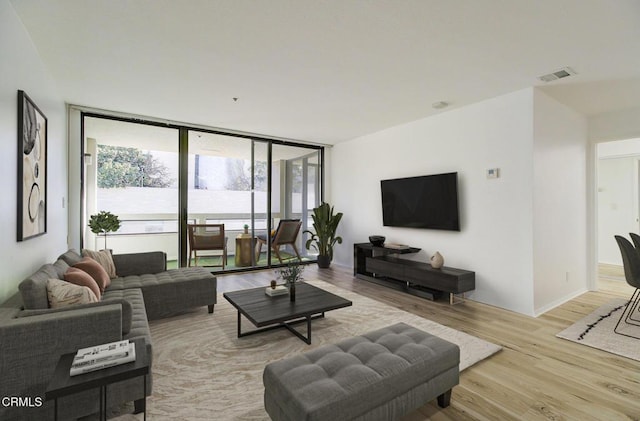 121 S Hope St Unit 321, Los Angeles, CA 90012 - living room featuring light wood-style floors and expansive windows