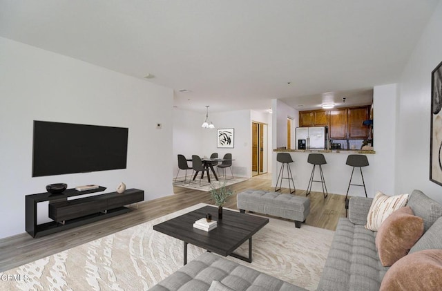 121 S Hope St Unit 321, Los Angeles, CA 90012 - living room with light wood finished floors and a chandelier