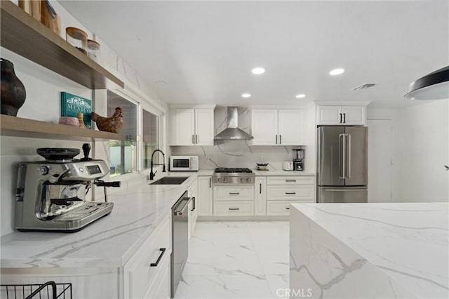8873 Reche Canyon Rd, Colton, CA 92324 - kitchen featuring appliances with stainless steel finishes, open shelves, wall chimney range hood, recessed lighting, and light marble finish floors