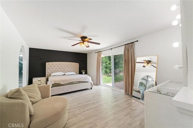 8873 Reche Canyon Rd, Colton, CA 92324 - bedroom with access to outside, washer / dryer, light wood-type flooring, arched walkways, and a ceiling fan