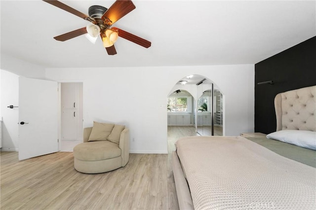 8873 Reche Canyon Rd, Colton, CA 92324 - bedroom featuring arched walkways, light wood-style flooring, and ceiling fan