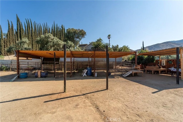 8873 Reche Canyon Rd, Colton, CA 92324 - view of patio with an exterior structure, a mountain view, and an outbuilding