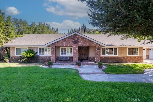 8873 Reche Canyon Rd, Colton, CA 92324 - ranch-style home with brick siding, a front lawn, and roof with shingles