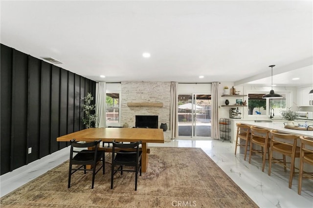 8873 Reche Canyon Rd, Colton, CA 92324 - dining space with light marble finish flooring, a fireplace, and recessed lighting