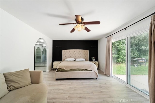8873 Reche Canyon Rd, Colton, CA 92324 - bedroom featuring access to exterior, arched walkways, light wood finished floors, and ceiling fan