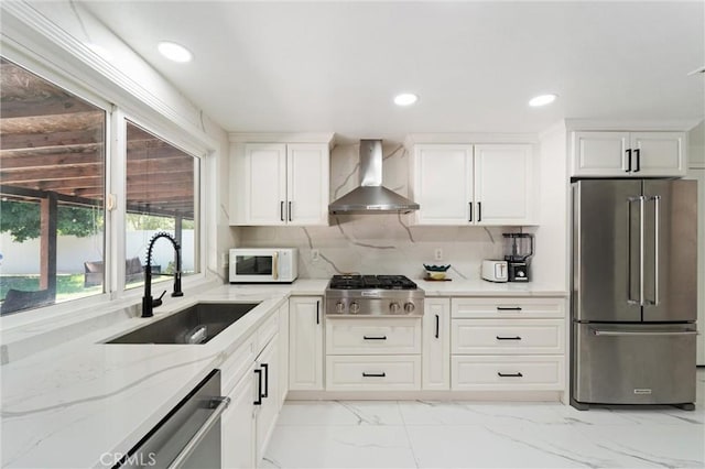 8873 Reche Canyon Rd, Colton, CA 92324 - kitchen with appliances with stainless steel finishes, wall chimney exhaust hood, light marble finish flooring, light stone counters, and recessed lighting