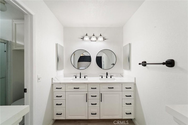 8873 Reche Canyon Rd, Colton, CA 92324 - bathroom featuring double vanity and a shower with door