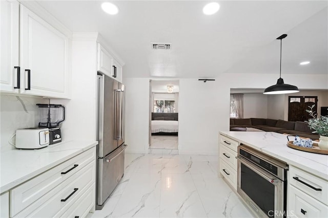 8873 Reche Canyon Rd, Colton, CA 92324 - kitchen with appliances with stainless steel finishes, recessed lighting, light stone counters, open floor plan, and white cabinets