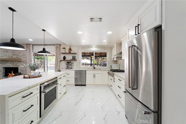 8873 Reche Canyon Rd, Colton, CA 92324 - kitchen with stainless steel appliances, recessed lighting, open shelves, white cabinets, and a fireplace