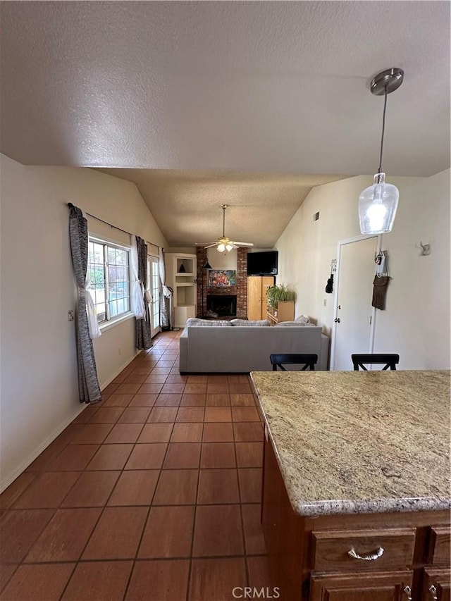 37510 Conifer Dr, Palmdale, CA 93550 - dining room with vaulted ceiling, a textured ceiling, tile patterned floors, a brick fireplace, and ceiling fan