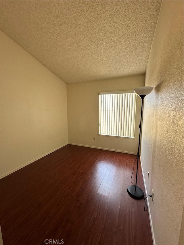 37510 Conifer Dr, Palmdale, CA 93550 - empty room featuring a textured ceiling, wood finished floors, and a textured wall