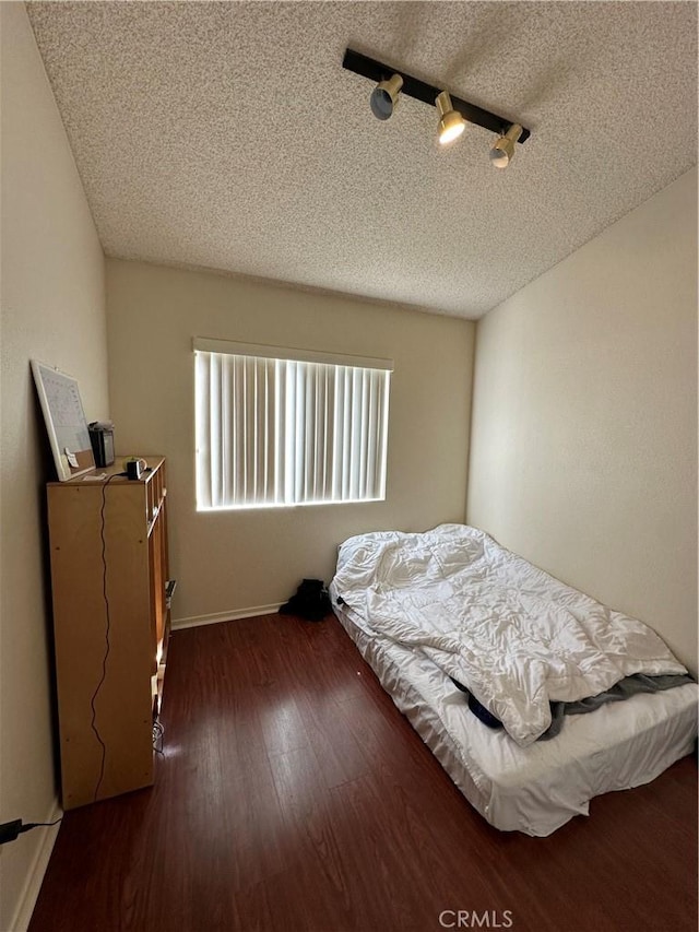 37510 Conifer Dr, Palmdale, CA 93550 - bedroom featuring a textured ceiling and dark wood-type flooring