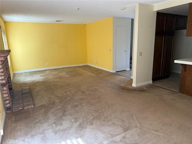 640 Juniper Way, La Habra, CA 90631 - unfurnished living room with light colored carpet, a textured ceiling, and a fireplace