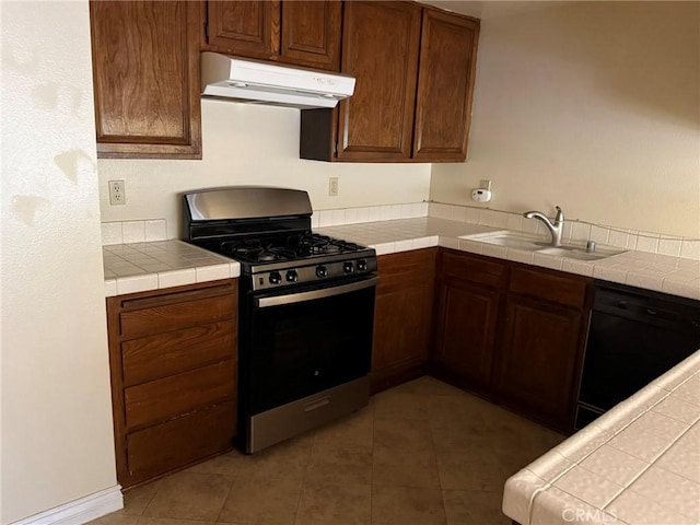 640 Juniper Way, La Habra, CA 90631 - kitchen with stainless steel gas range oven, range hood, dishwasher, tile countertops, and light tile patterned floors