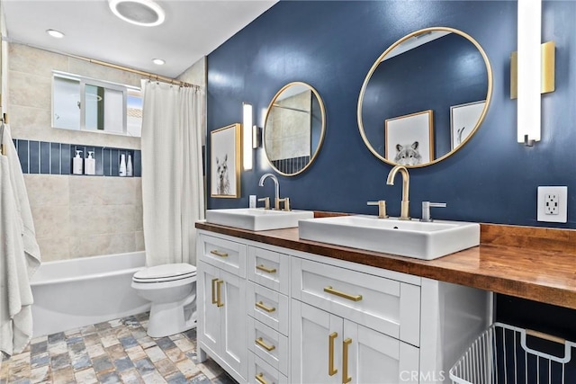 23906 Fernmead Ln, Harbor City, CA 90710 - full bathroom featuring double vanity, shower / bathtub combination with curtain, and stone finish floors