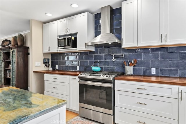 23906 Fernmead Ln, Harbor City, CA 90710 - kitchen featuring wooden counters, stainless steel appliances, wall chimney exhaust hood, white cabinetry, and recessed lighting
