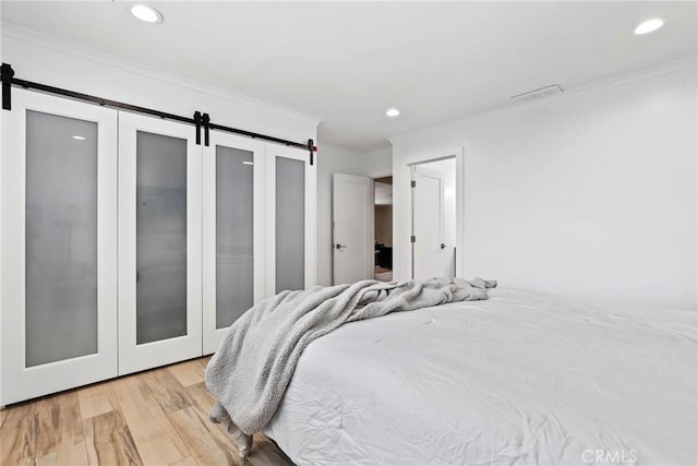 23906 Fernmead Ln, Harbor City, CA 90710 - bedroom with a barn door, crown molding, light wood-type flooring, and recessed lighting