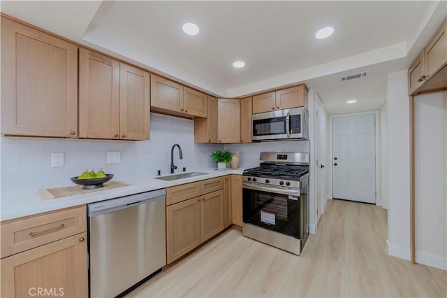 1615 Via Linda Unit 16, Fullerton, CA 92833 - kitchen with stainless steel appliances, light wood-style flooring, light countertops, light brown cabinets, and recessed lighting
