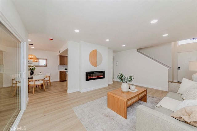 1615 Via Linda Unit 16, Fullerton, CA 92833 - living room featuring light wood-style floors, recessed lighting, a glass covered fireplace, and stairway