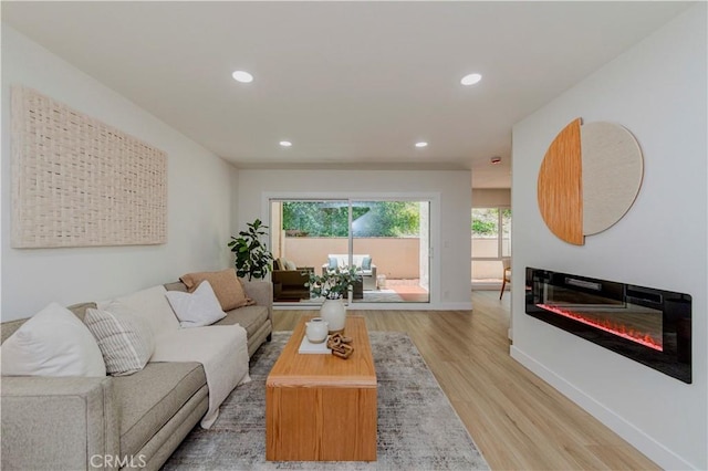 1615 Via Linda Unit 16, Fullerton, CA 92833 - living area featuring light wood-style flooring, recessed lighting, and a glass covered fireplace