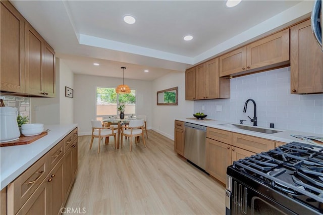 1615 Via Linda Unit 16, Fullerton, CA 92833 - kitchen featuring stainless steel dishwasher, light countertops, gas stove, light wood-type flooring, and backsplash
