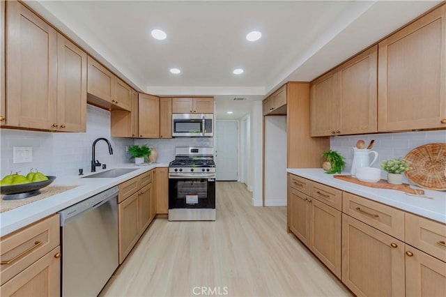 1615 Via Linda Unit 16, Fullerton, CA 92833 - kitchen with stainless steel appliances, light wood finished floors, light countertops, backsplash, and recessed lighting