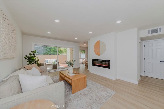 1615 Via Linda Unit 16, Fullerton, CA 92833 - living area featuring light wood-style flooring, a glass covered fireplace, and recessed lighting