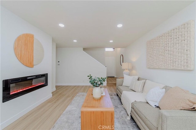1615 Via Linda Unit 16, Fullerton, CA 92833 - living area featuring light wood finished floors, recessed lighting, stairway, and a glass covered fireplace