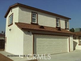 12902 Indian St, Moreno Valley, CA 92553 - view of front of home with stucco siding, a garage, and driveway