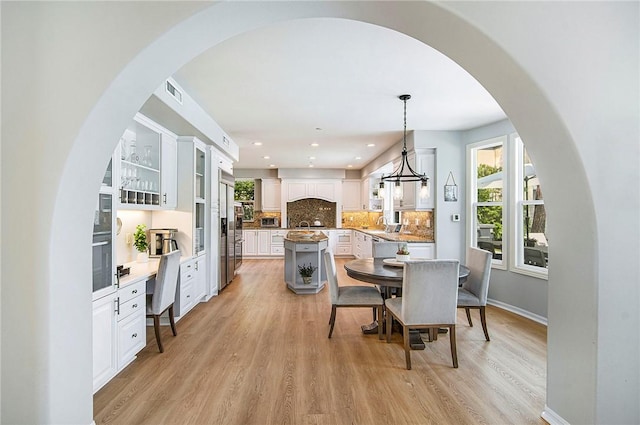 3417 Kildare Ct, Burbank, CA 91504 - dining space featuring light wood-style floors, arched walkways, and recessed lighting