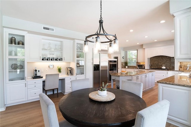 3417 Kildare Ct, Burbank, CA 91504 - dining room with light wood-style flooring, built in study area, and recessed lighting