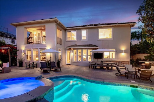 3417 Kildare Ct, Burbank, CA 91504 - back of house featuring a balcony, a pool with connected hot tub, a patio, and stucco siding