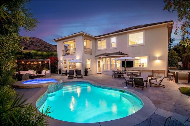 3417 Kildare Ct, Burbank, CA 91504 - rear view of property featuring a balcony, an outdoor hangout area, a patio, stucco siding, and a pool with connected hot tub