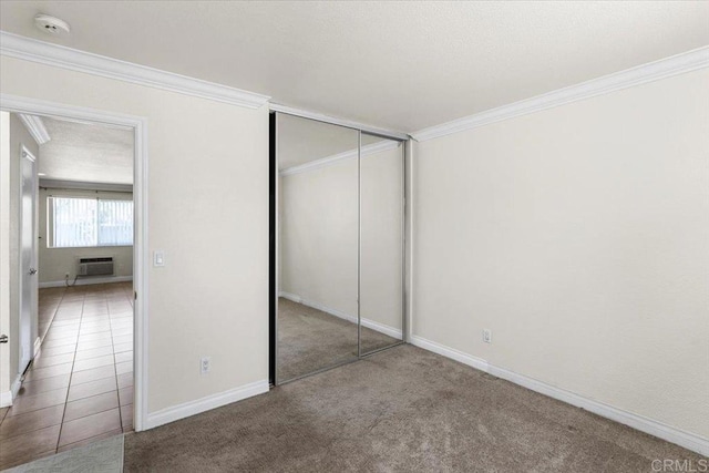 390 N 1st St Unit 23, El Cajon, CA 92021 - unfurnished bedroom featuring carpet flooring, a wall unit AC, crown molding, and a closet