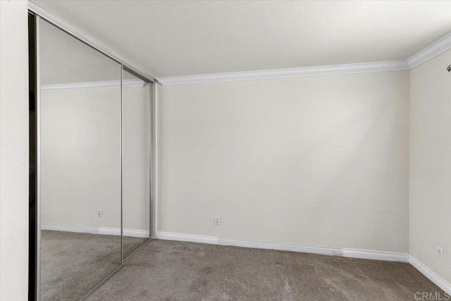 390 N 1st St Unit 23, El Cajon, CA 92021 - unfurnished bedroom featuring carpet, crown molding, and a closet