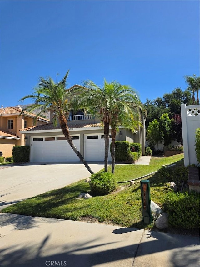 29390 Crest View Ln, Highland, CA 92346 - view of front facade with concrete driveway, stucco siding, and a front yard