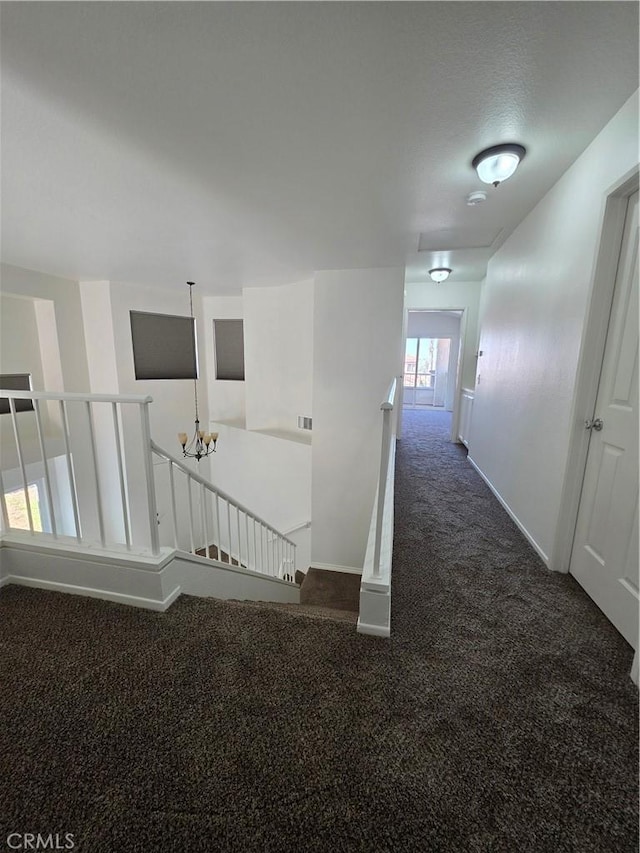 29390 Crest View Ln, Highland, CA 92346 - hall featuring an upstairs landing, dark carpet, and a chandelier